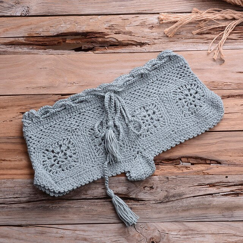 Handcrafted gray crochet bikini set on rustic wooden background